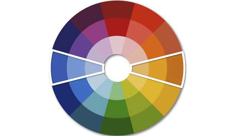 A color wheel with a white perimeter around a section of blue hues and section of orange hues.