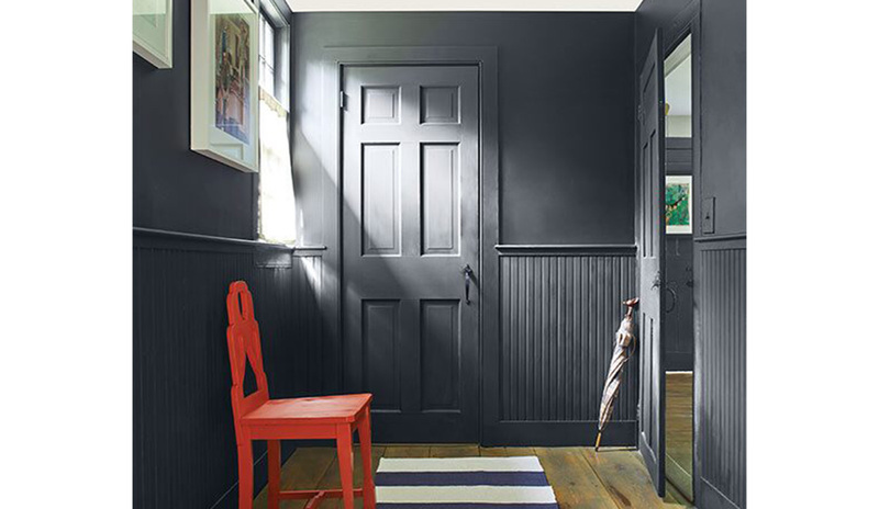 Red chair in a mudroom with walls painted in Soot 2129-20.