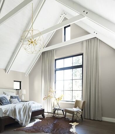 Top floor bedroom with high white ceilings and neutral color palettes