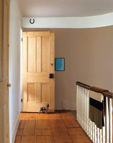 An airy hallway with neutral walls and crisp white trim