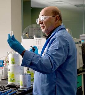 A senior scientist in Benjamin Moore’s R&D lab measures samples of Natura Interior paint.