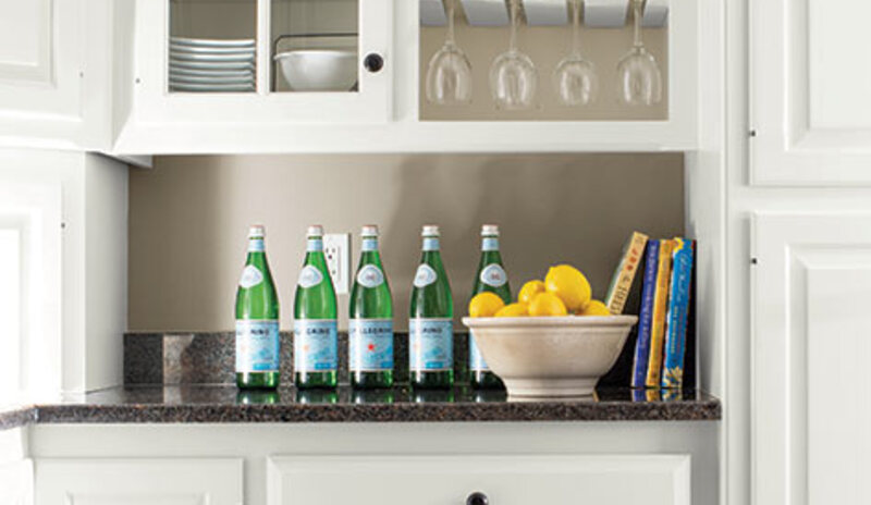 A before and after of a built-in wine rack, glass-paneled cabinet and kitchen drawers showcase an al