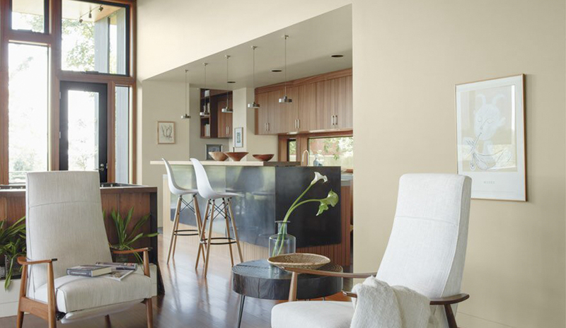 A neutral wood-based kitchen opens to an inviting living room