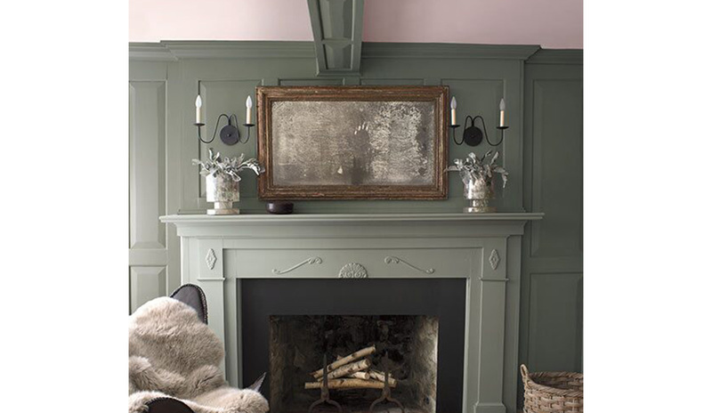 Olive green-painted walls with a light pink-painted ceiling and a muted green fireplace mantle.