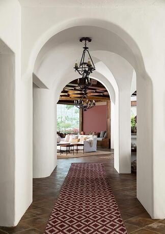 Crisp white painted atrium leading to a warm living room.