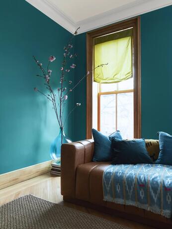 living room painted in North Sea Green with White Heron trim, Etiquette off white-painted ceiling. 