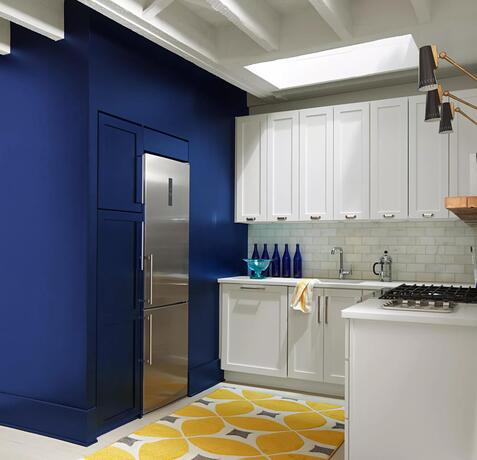 Starry Night Blue-painted accent walls in a kitchen with White Heron-painted cabinets.