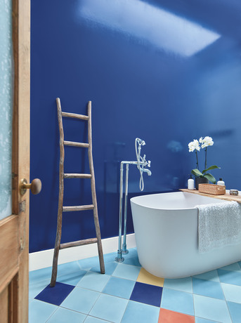 Starry Night Blue-painted bathroom with large tub and trim painted in White Heron.