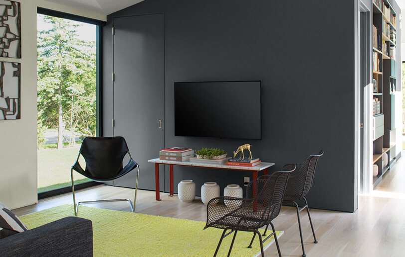 Contemporary living room with dark gray feature wall.