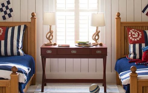 Nautical bedroom with white shiplap walls and two twin size beds.