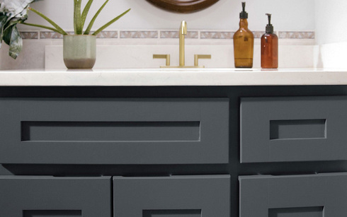 A close-up of a dark bathroom vanity cabinet with color  Van Deusen Blue HC-156 